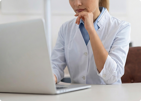 Physician reviewing patient data on a monitor Why Choose Us